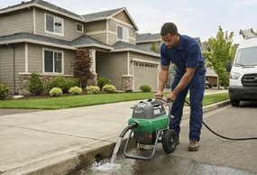 Plumber operating water management equipment for sump pump and drainage service
