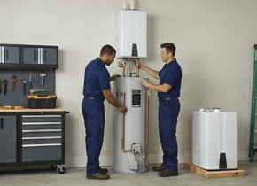 Two plumbers installing a new water heater in a Beaverton home